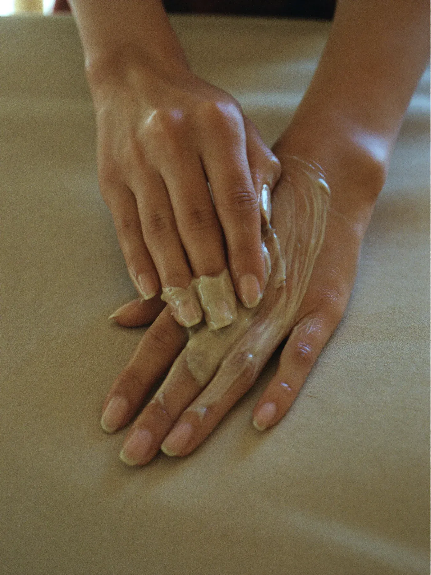 Hands with a moisturising balm worked into the skin